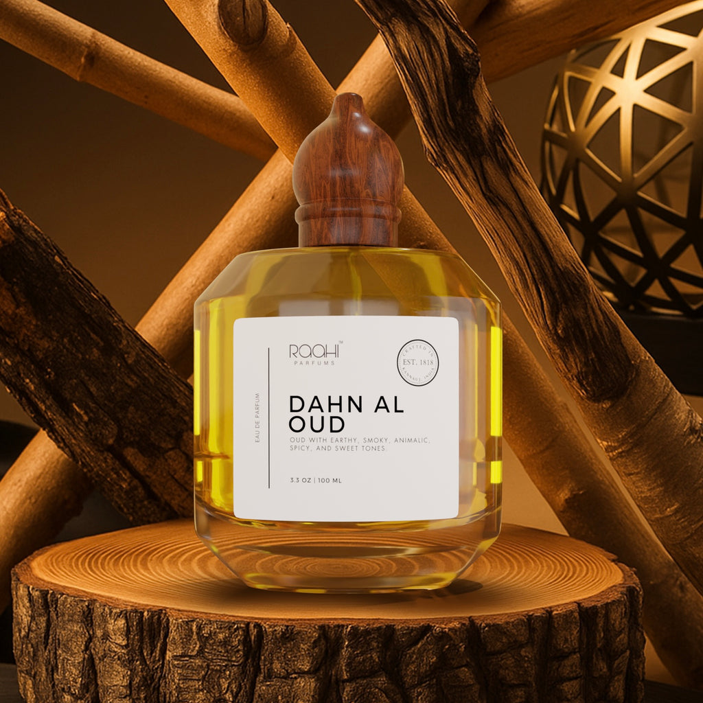 A clear glass bottle with wooden stopper containing golden yellow dahn al oud eau de parfum by roohi parfums
