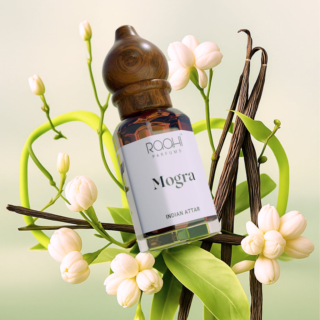 A sleek dark amber glass bottle with a wooden dropper cap labeled roohi parfums mogra indian attar handcrafted in Kannauj
