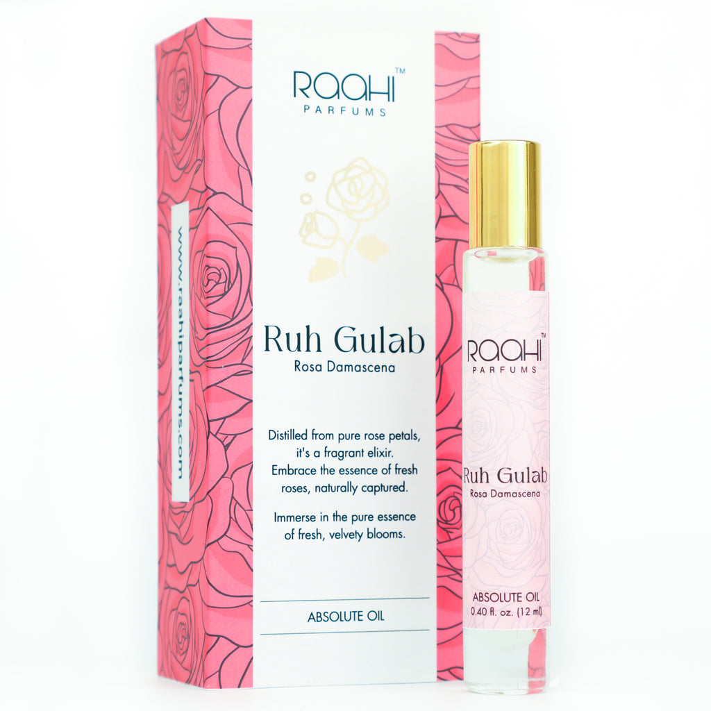 Pink rose-scented roll-on perfume bottle with gold cap and clear glass body branded ruh gulab by raahi parfums 12ml