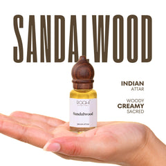 A small clear glass bottle with dark brown wooden stopper containing golden-yellow sandalwood attar handcrafted in Kannauj